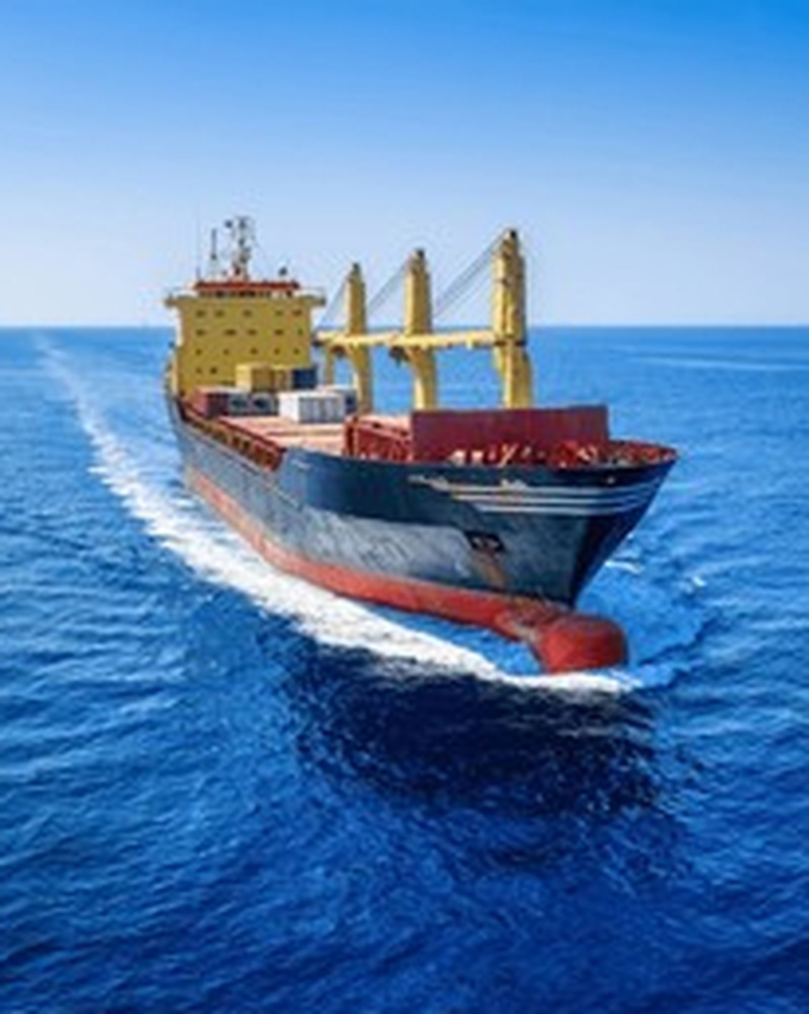 A loaded bulk carrier at anchor in open water.