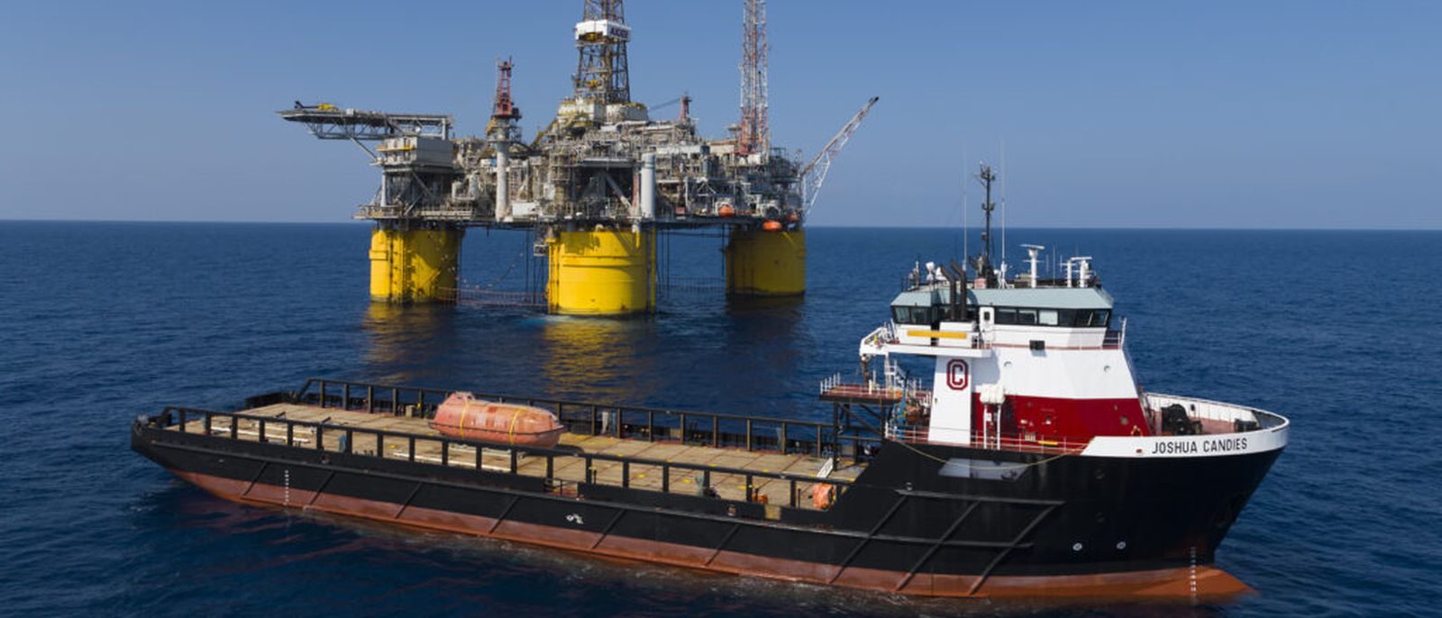 An offshore supply vessel working alongside a platform.