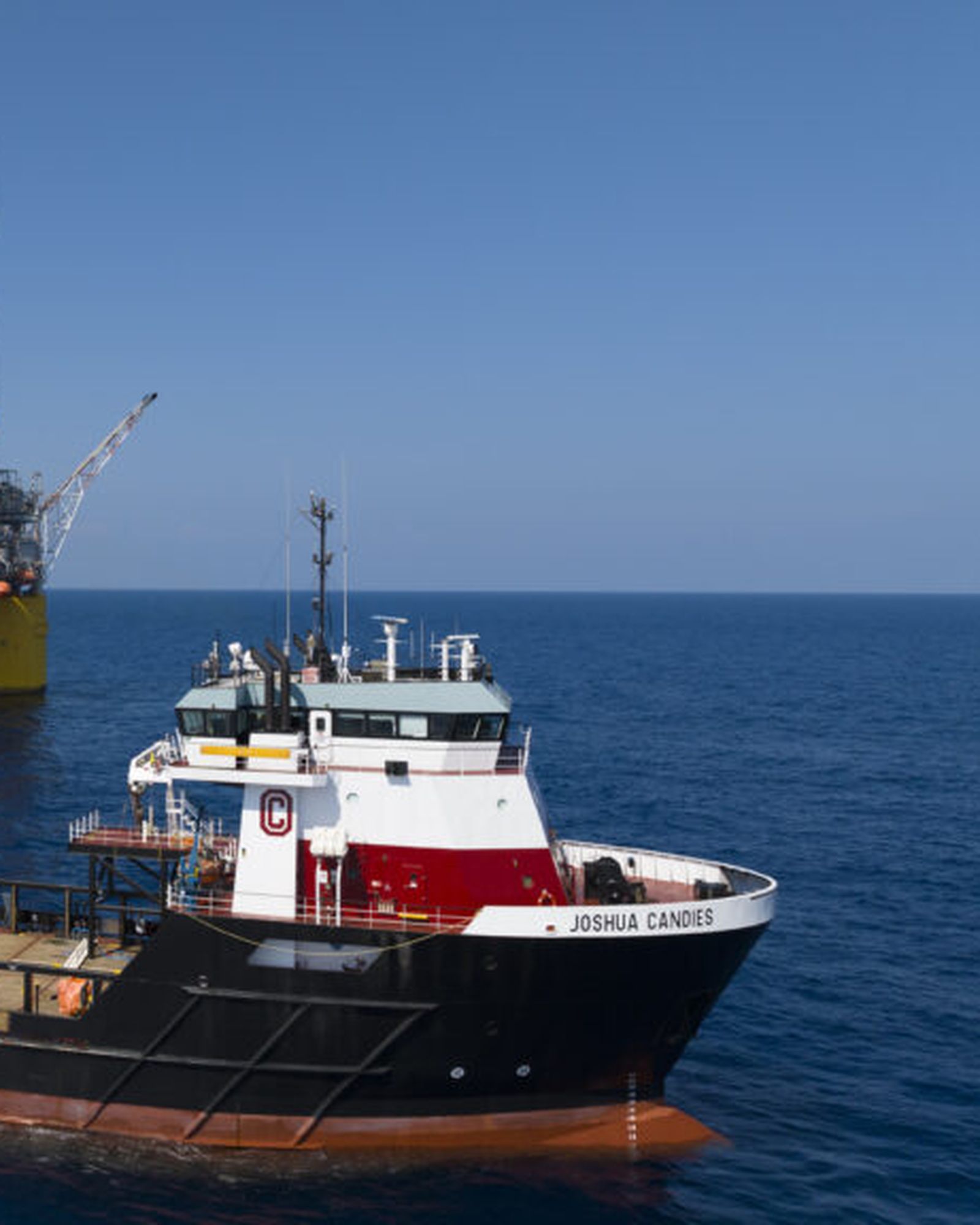 An offshore supply vessel working alongside a platform.