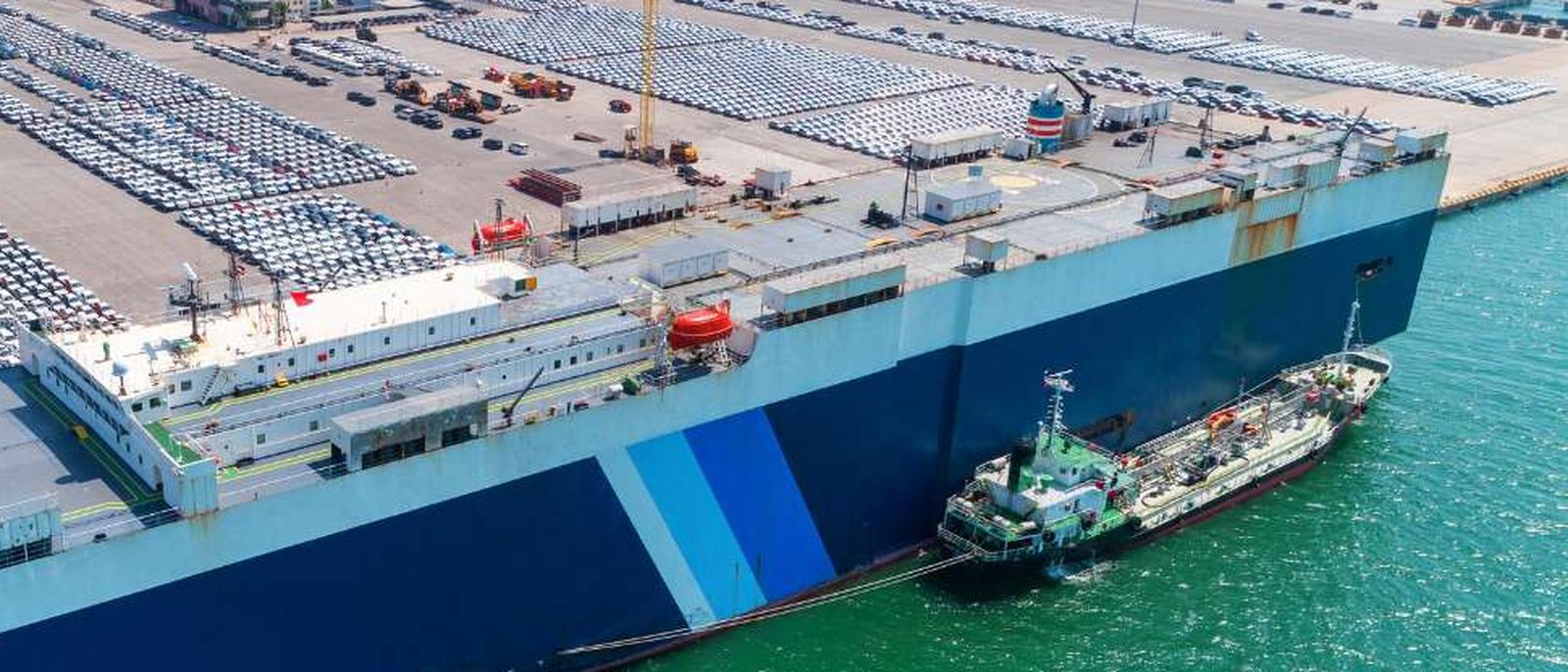 A ro-ro vessel with her stern ramp down at a freight terminal.